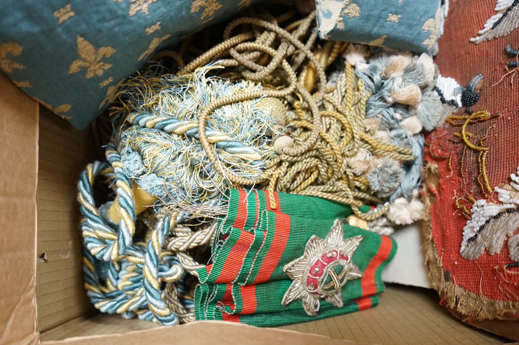 A 19th century beadwork panel and bell pull, various samples of printed textiles, a collection of corded and tasselled tie backs, etc.